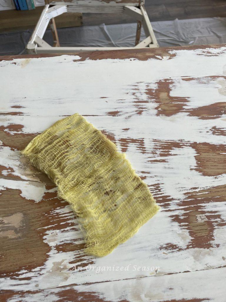 Wipe furniture with a tack cloth before you paint it. 