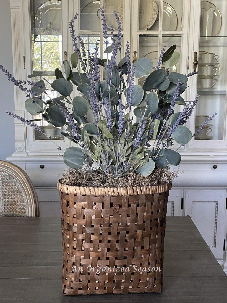 Step four to make a lavender wreath is to add moss to the top of basket to cover brown paper.  