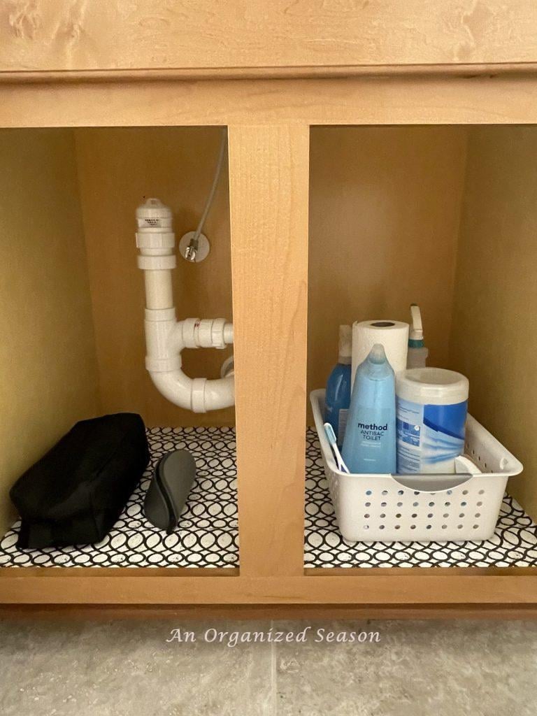 Organize a bathroom cabinet or drawer with plastic bins.