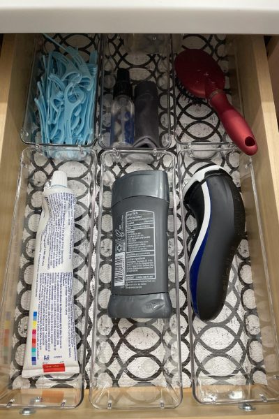 Bathroom drawer organized with clear bins.