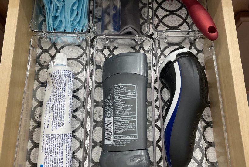 Bathroom drawer organized with clear bins.
