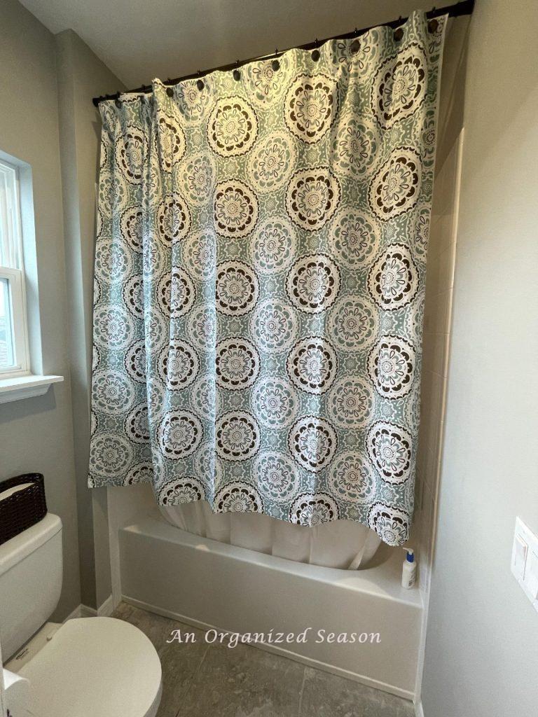 A shower curtain that is way too short for the bathroom it's hanging in.