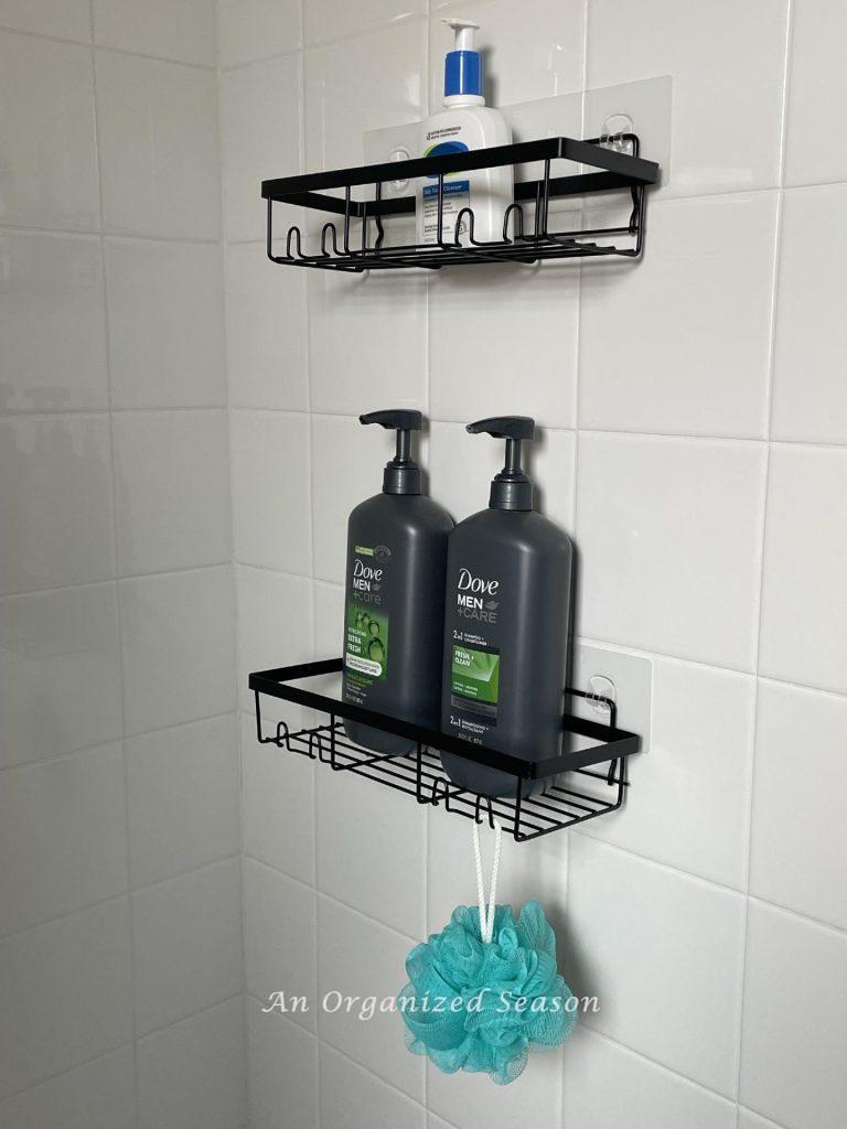 Wire shelves hanging in a shower holding bath products. 