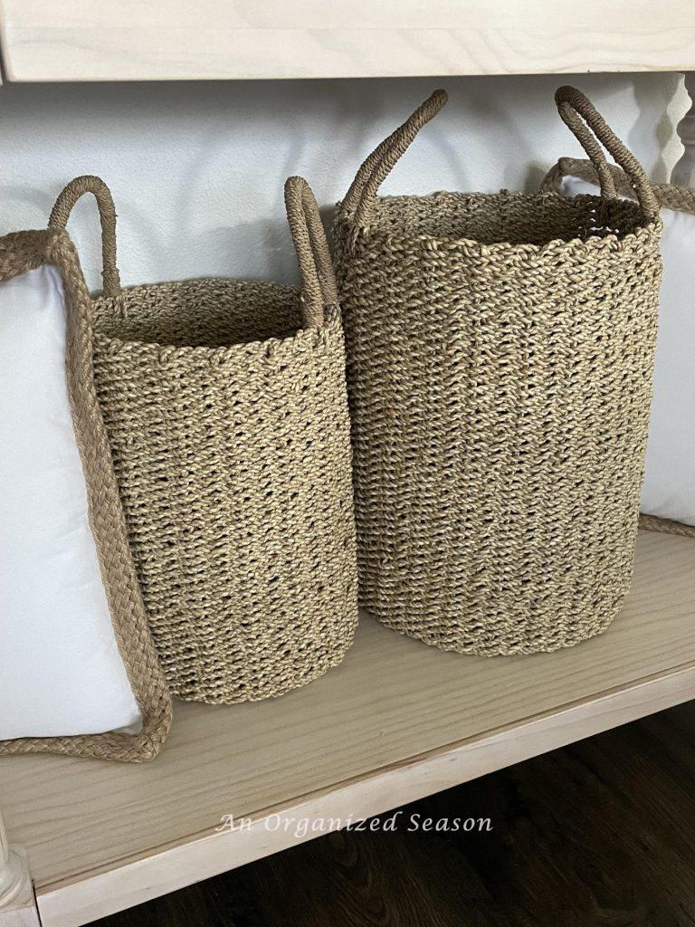 Two tall thin storage baskets with handles are yard sale treasures! 