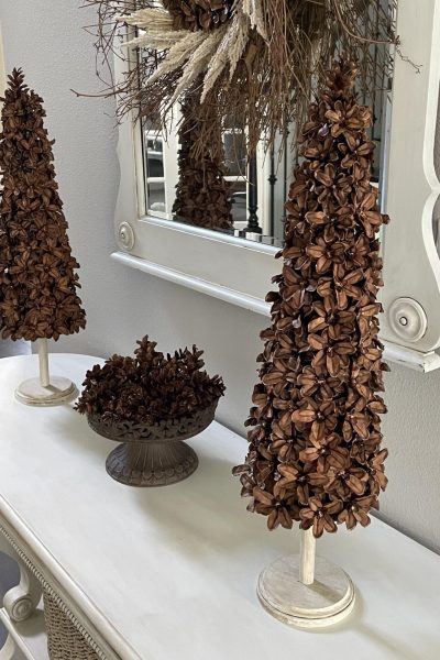 Two Pinecone Flower Christmas trees displayed on a table.