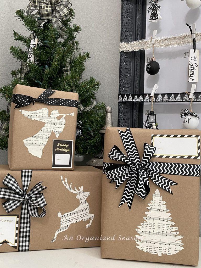 Christmas gifts wrapped in brown paper with black and white bows and a book page sticker.