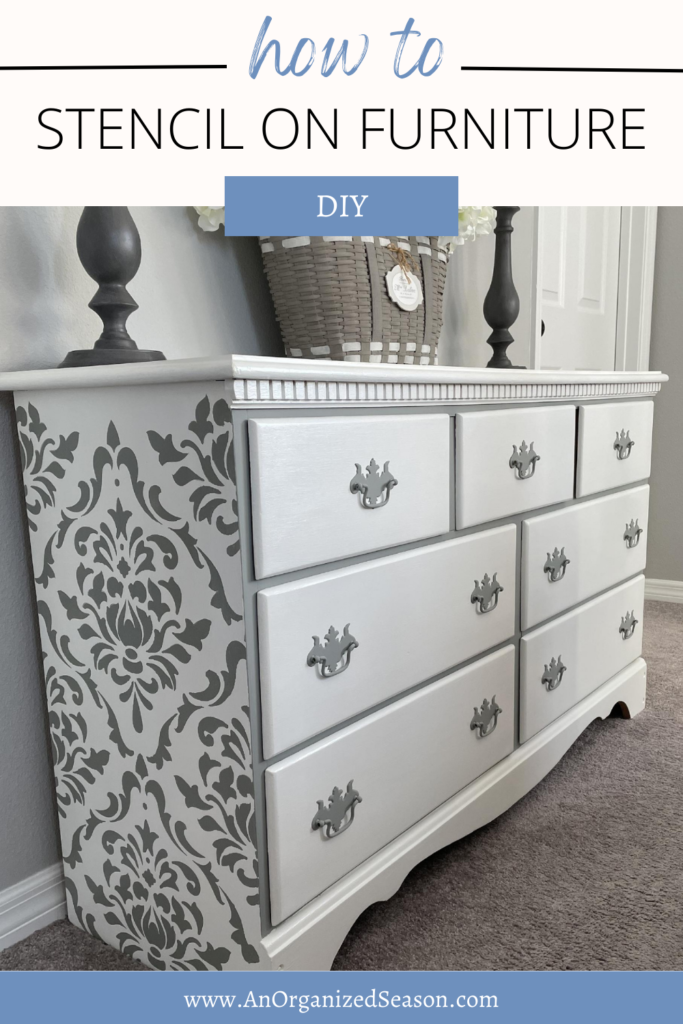 White dresser with gray damask design on the sides.