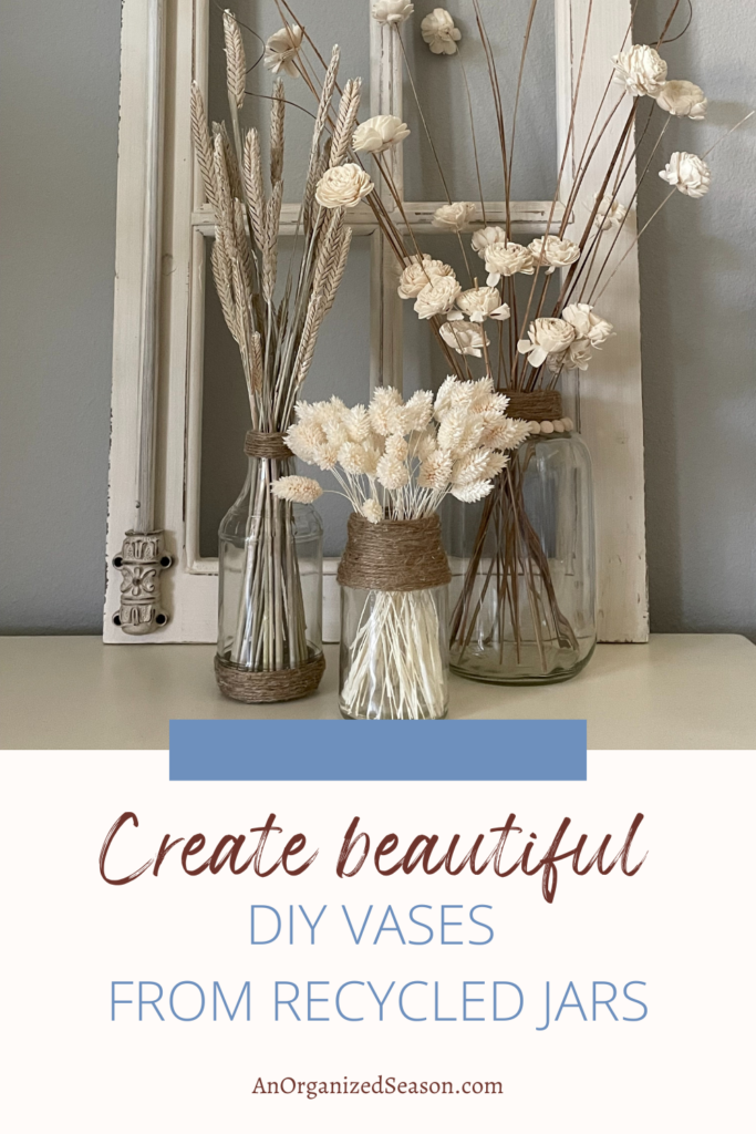 Three DIY vases filled with white flowers. 