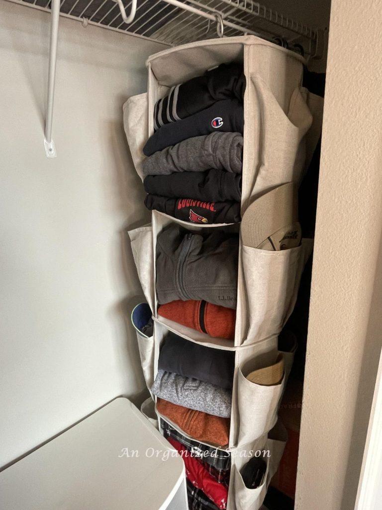 Closet organization idea # six is to use hanging shelves for folded clothes inside a closet.  