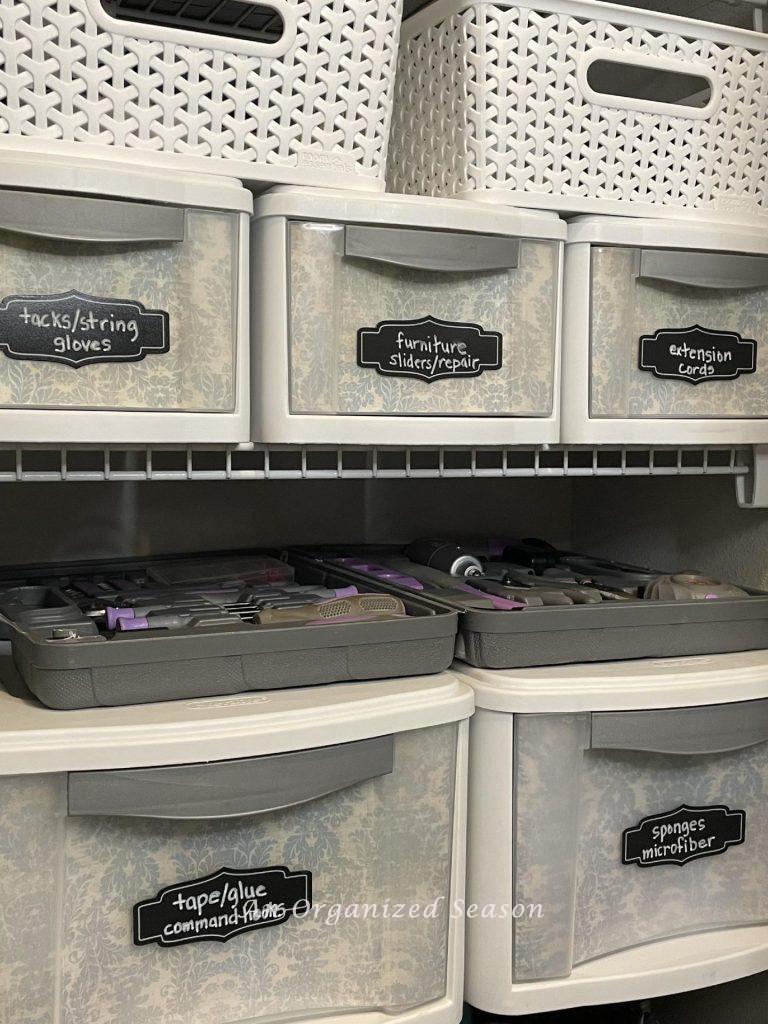 Pull-out drawers organized in a cleaning closet. 