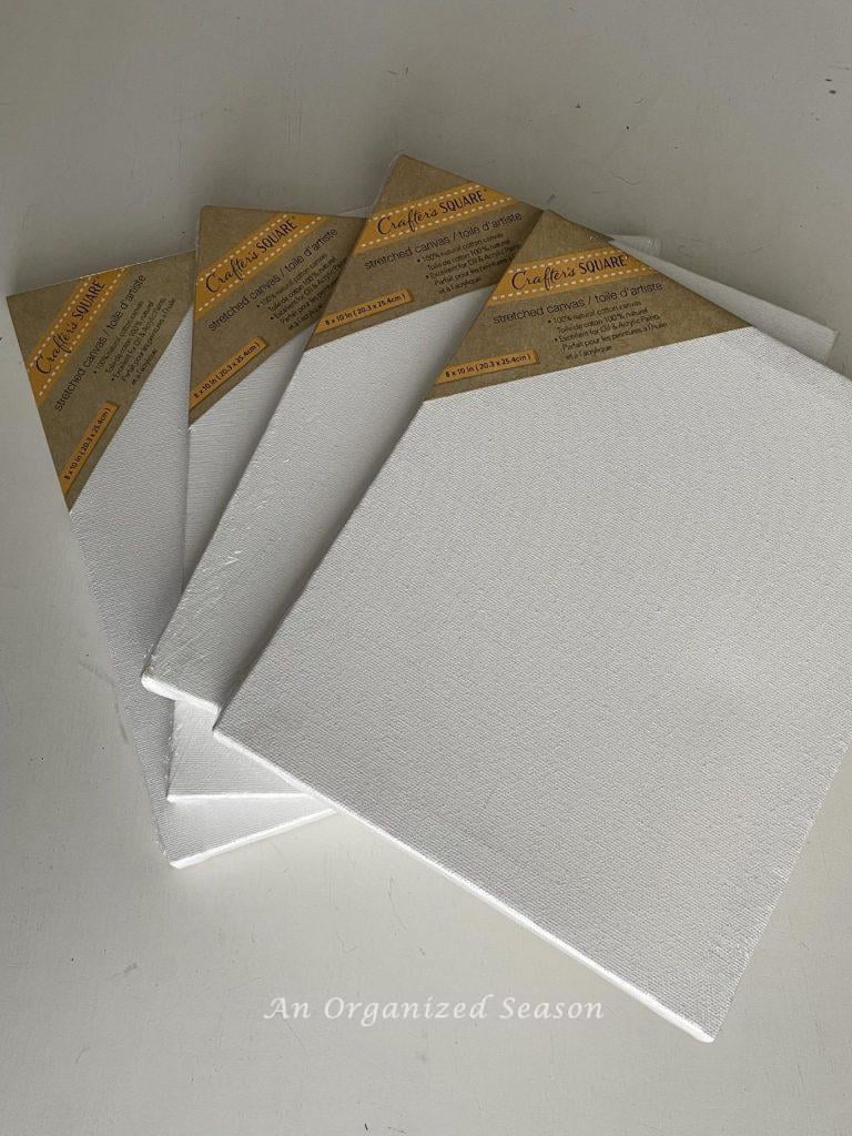 Step one to make framed canvas wall art is to purchase four blank canvases from Dollar Tree.