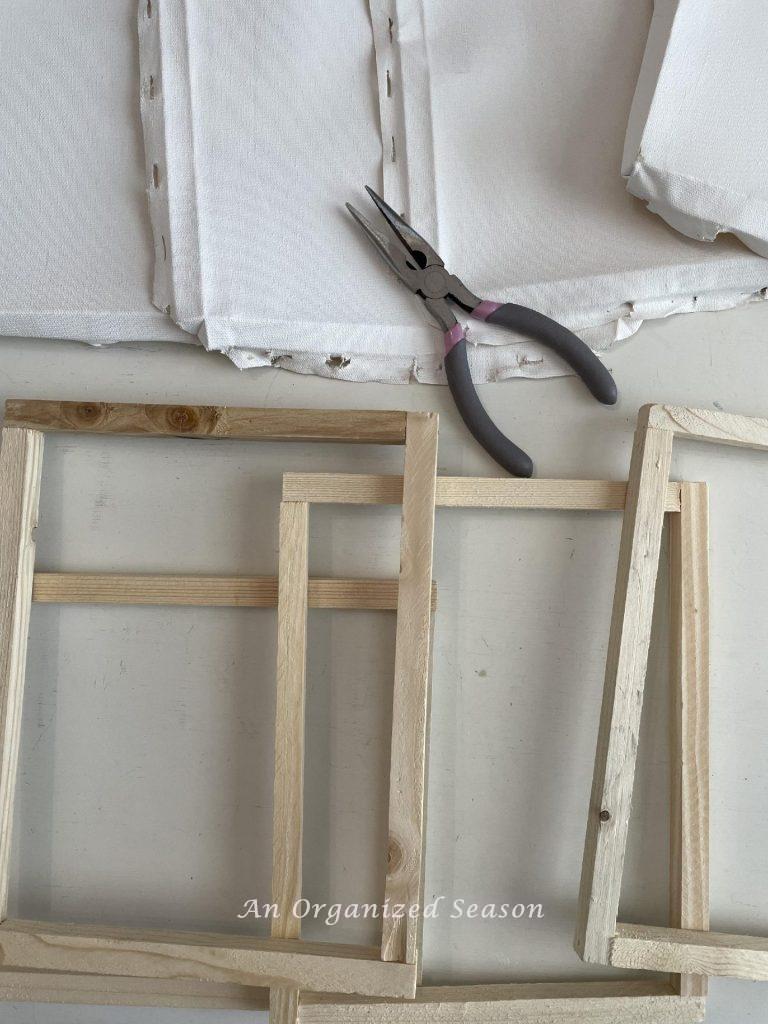 Step two to make framed canvas wall art is to remove the canvases from the frames.