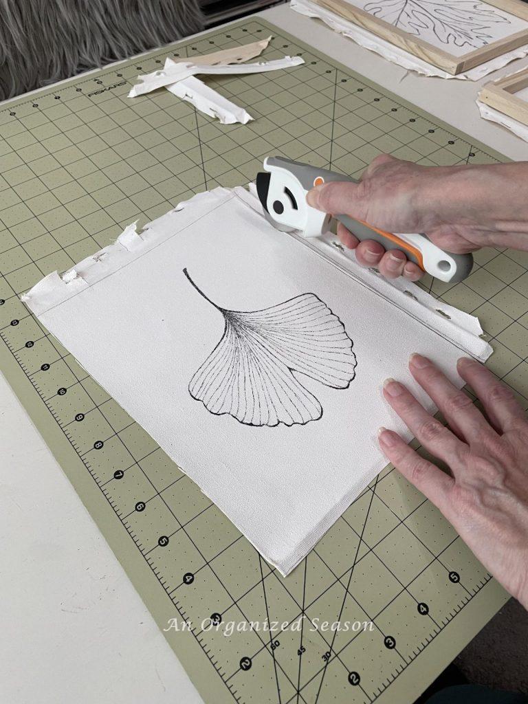 Step six to make framed canvas wall art is to cut the edges off the canvas.