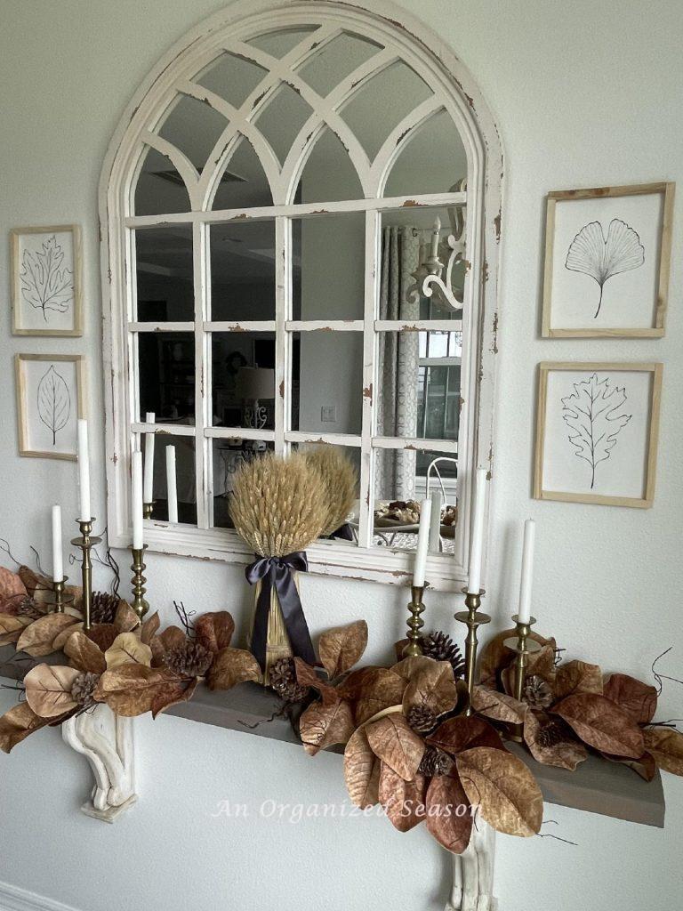 Four leaf pictures around a mirror.