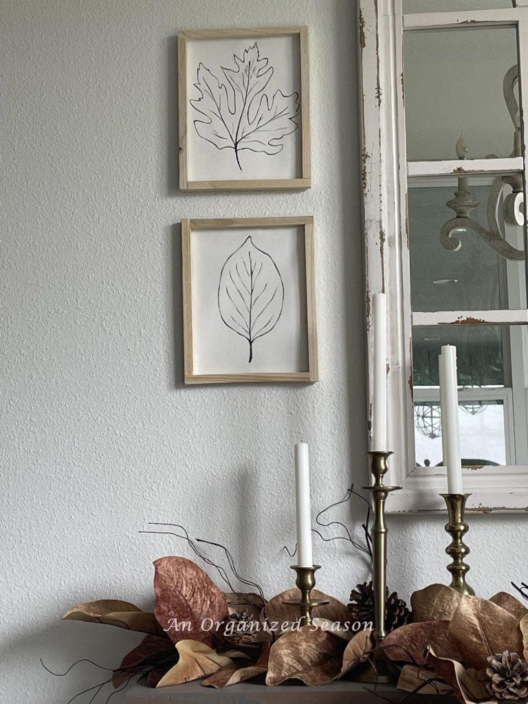 Two leaf pictures in light wood frames.