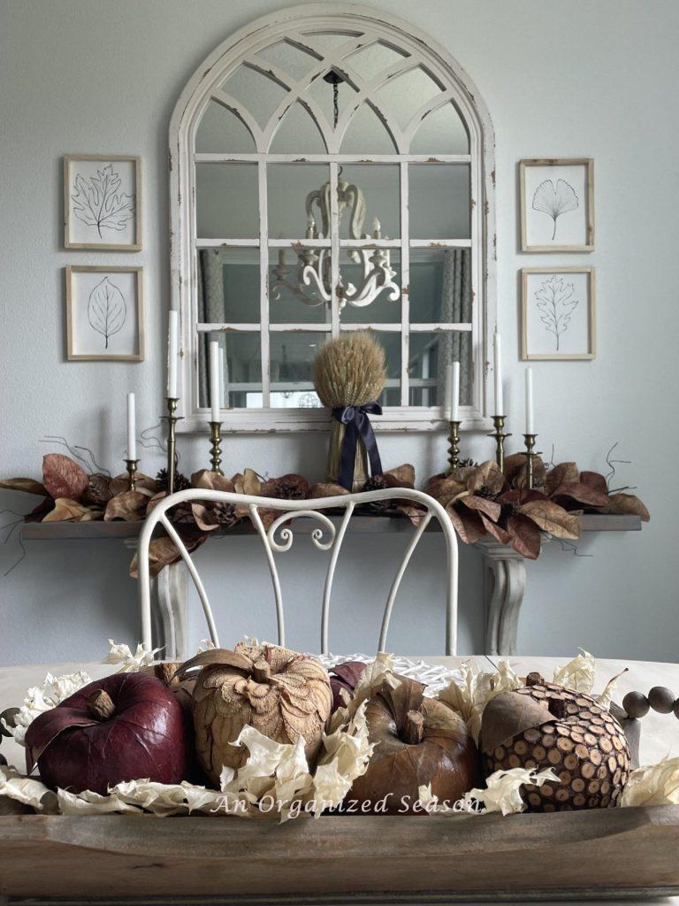 A kitchen eating area decorated for Fall with four leaf pictures. 