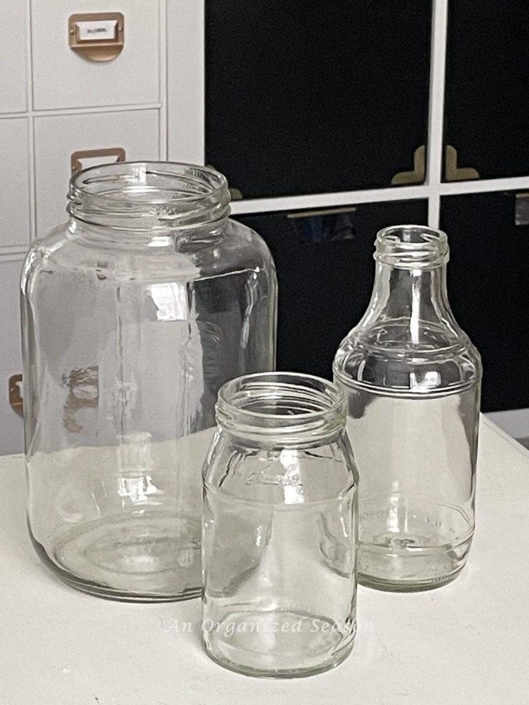 Step two to make a DIY vase is to clean three glass jars. 