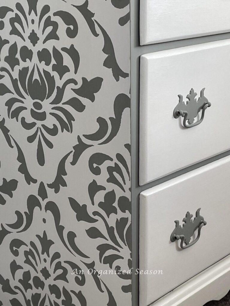 Damask stencil design painted on the side of a dresser. 