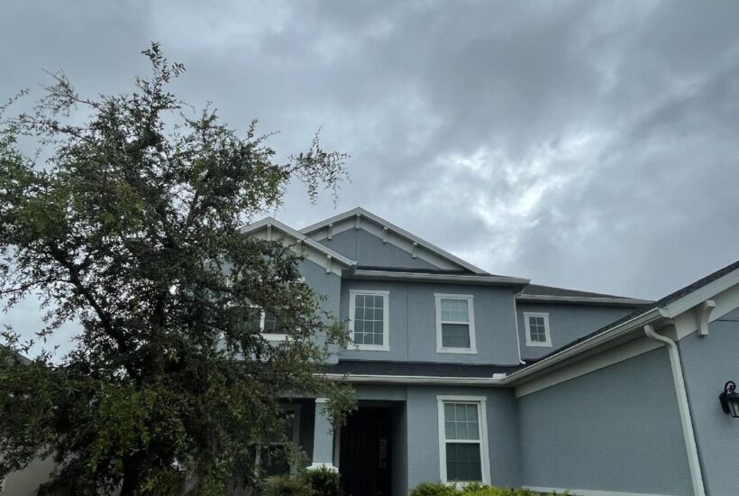 A house with storm clouds above.