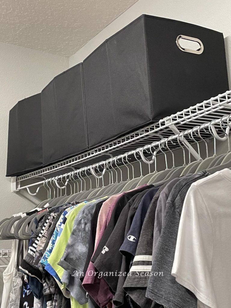 Closet organization idea # five is to use fabric cubes to store items on top shelf of a closet. 