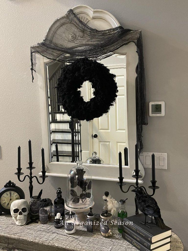 A creepy black wreath hanging above a Halloween apothecary! 