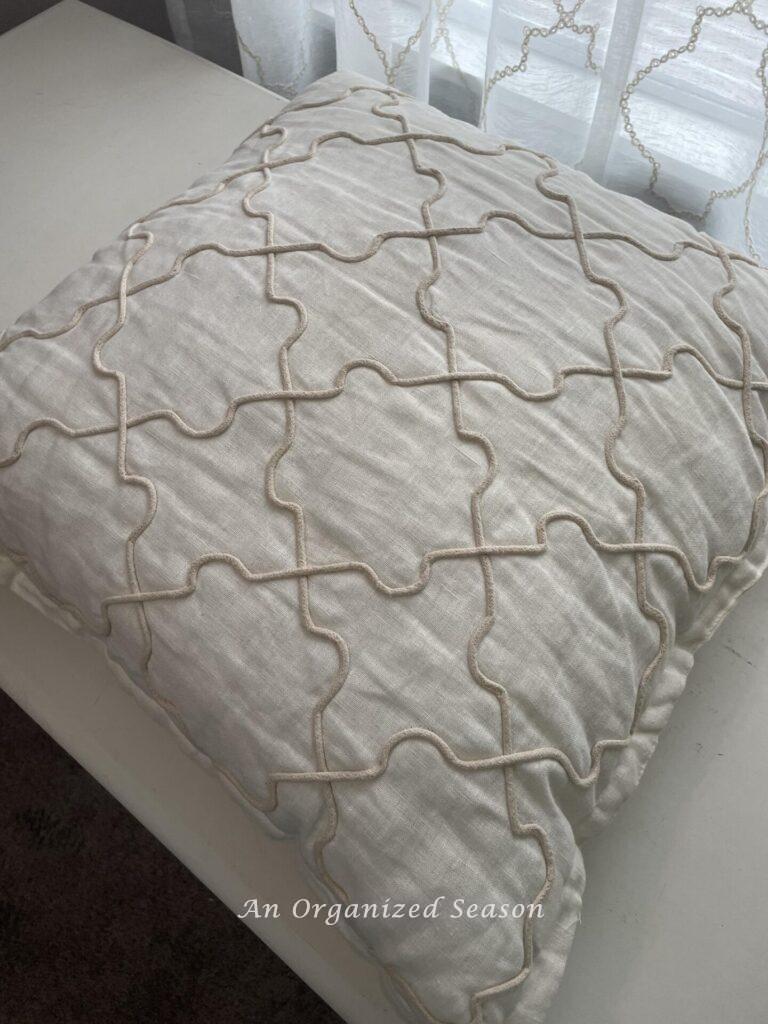 A neutral 24x24 pillow. 
