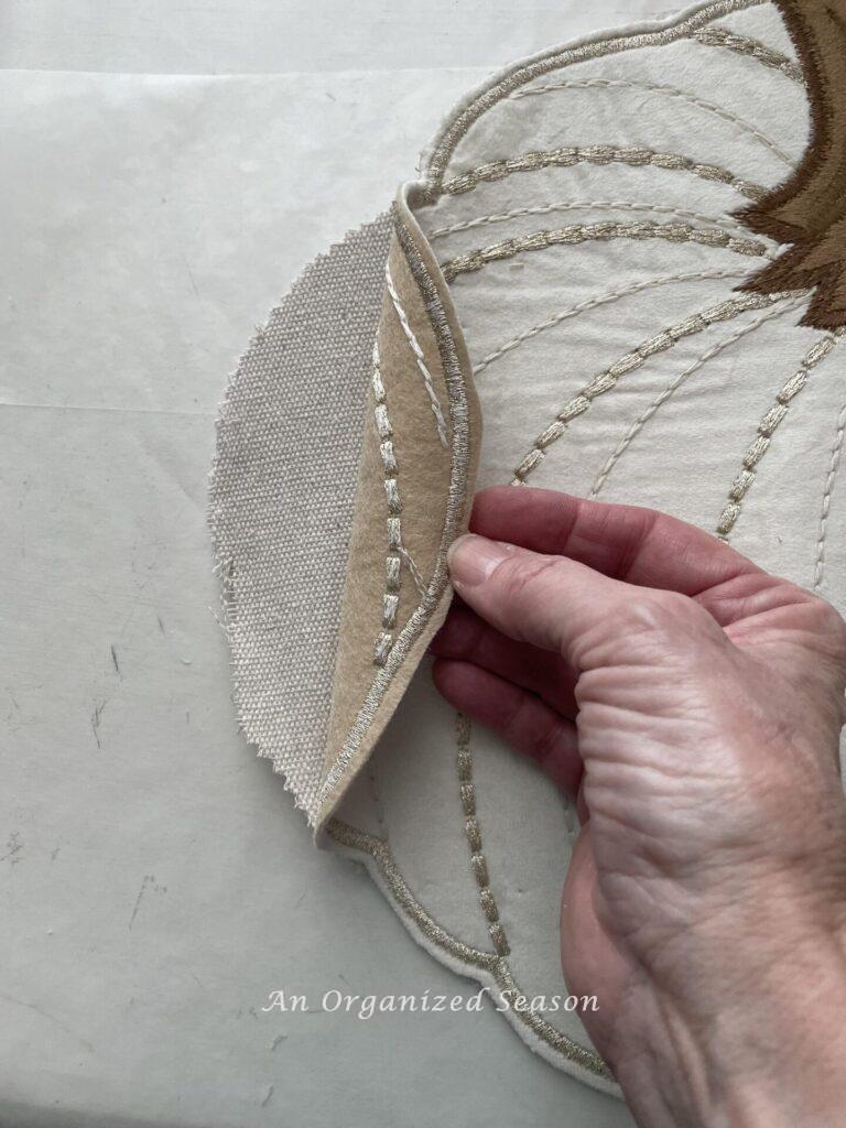 Put fiberfill into the opening to make a DIY pumpkin pillow .  