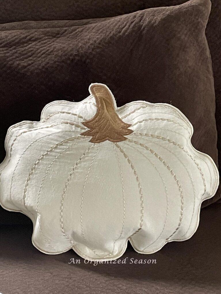 A pretty stuffed pumpkin pillow. 