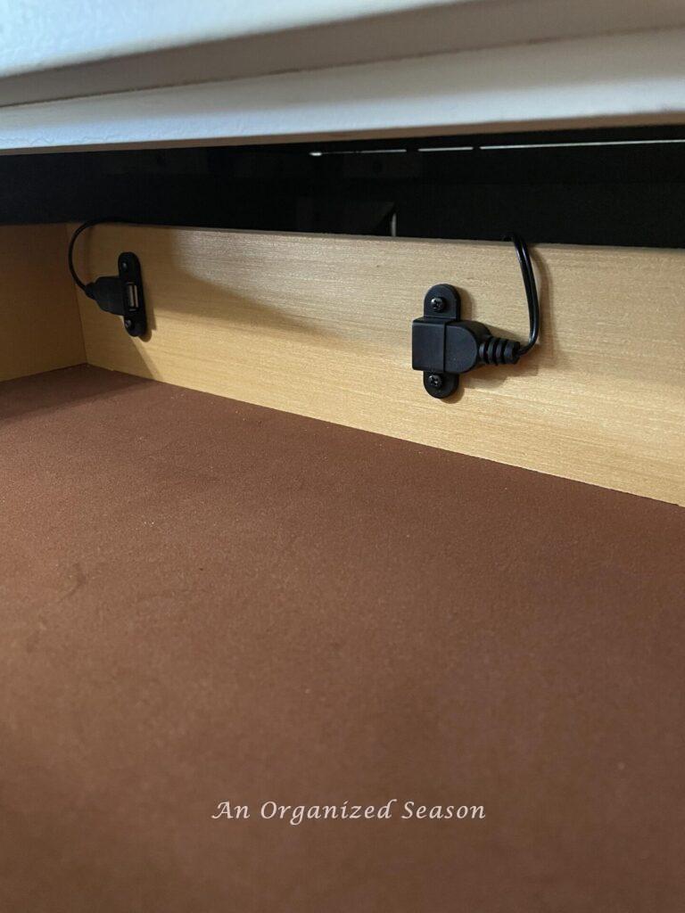 A good nightstand organization idea is to add two USB ports inside a drawer.