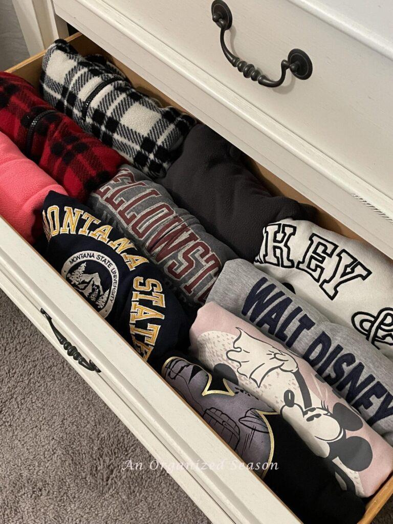 A good nightstand organization idea is to use the file fold technique for sweatshirts in a drawer. 