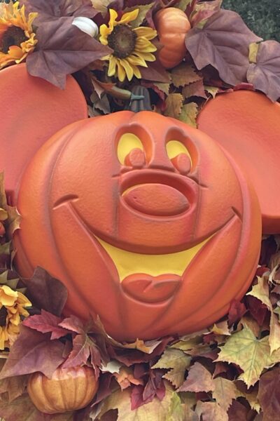 Mickey pumpkin head inside a fall wreath.