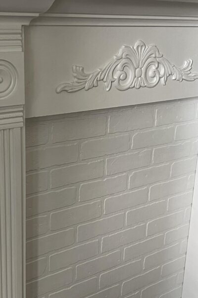 A white faux fireplace mantel