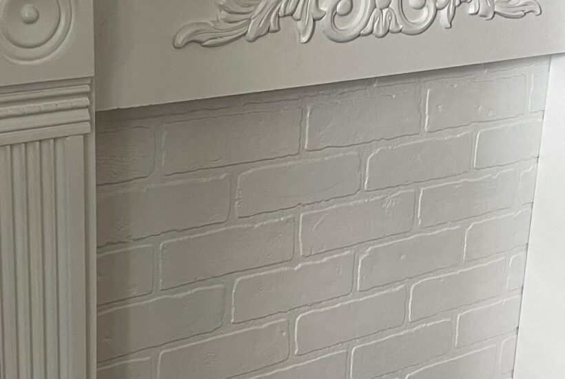 A white faux fireplace mantel