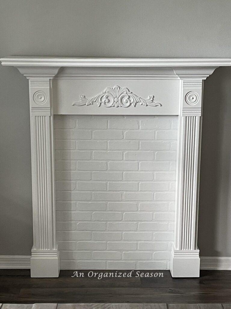 A White faux fireplace mantel.