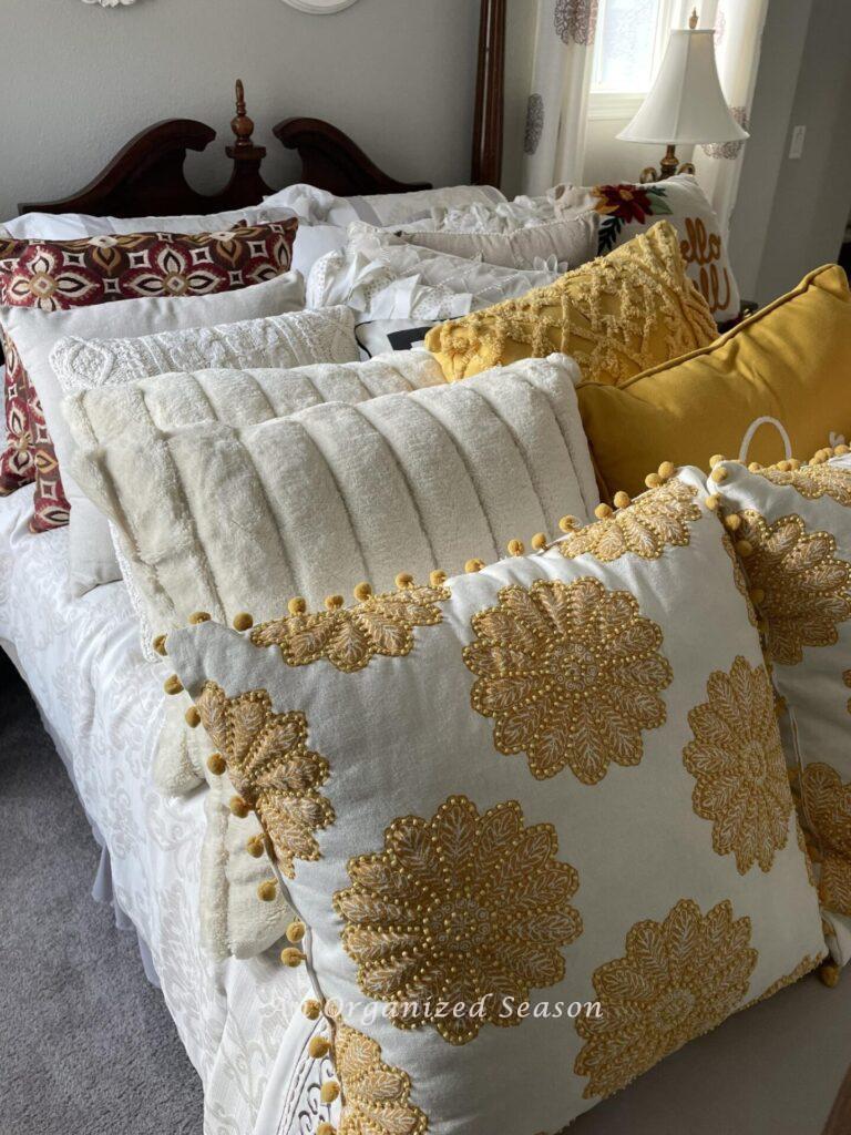 A bed completely covered in throw pillows. 