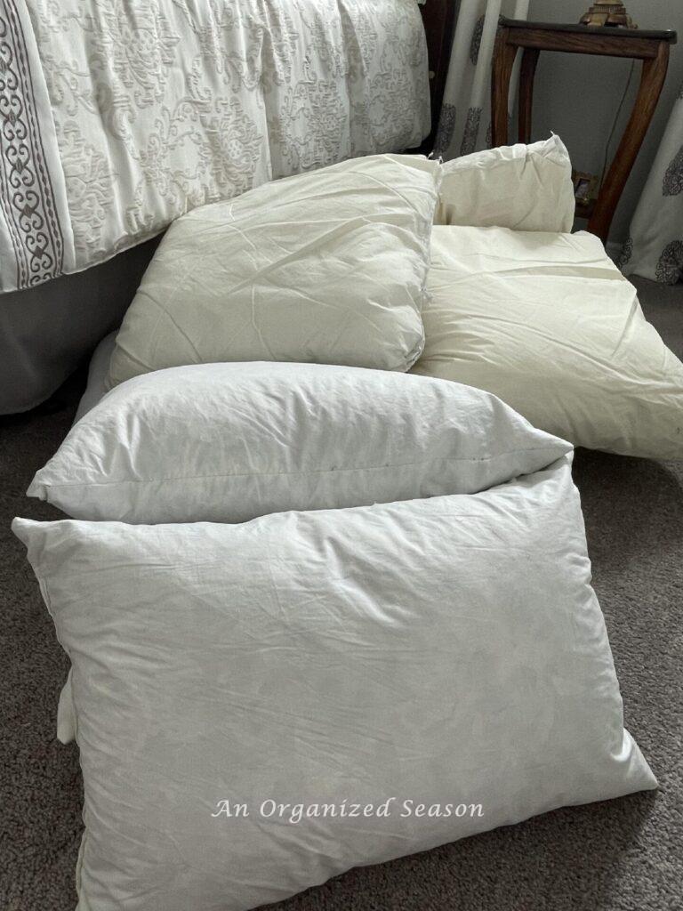 Pillow inserts laying on a bedroom floor. 