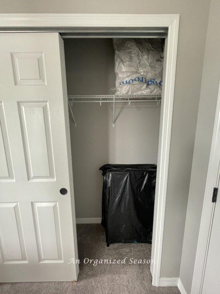 An organized closet with cots and vacuum sealed bags of pillows. 