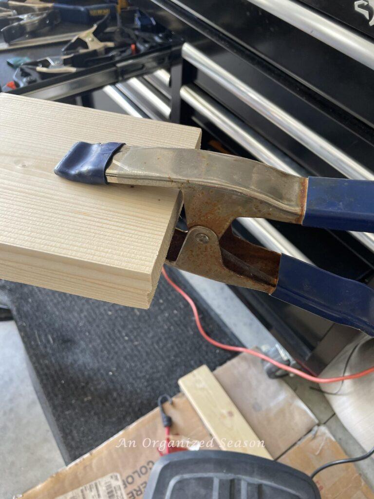 Clamp holding two board together