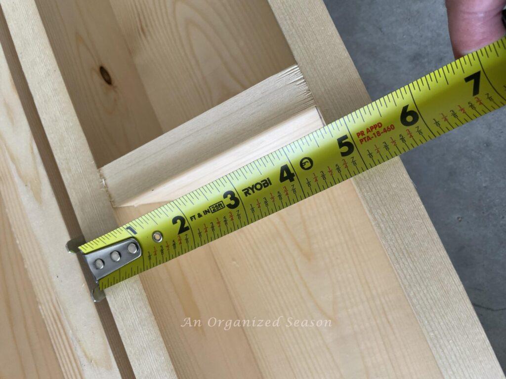 tape measure showing width of column to be five and one half inches