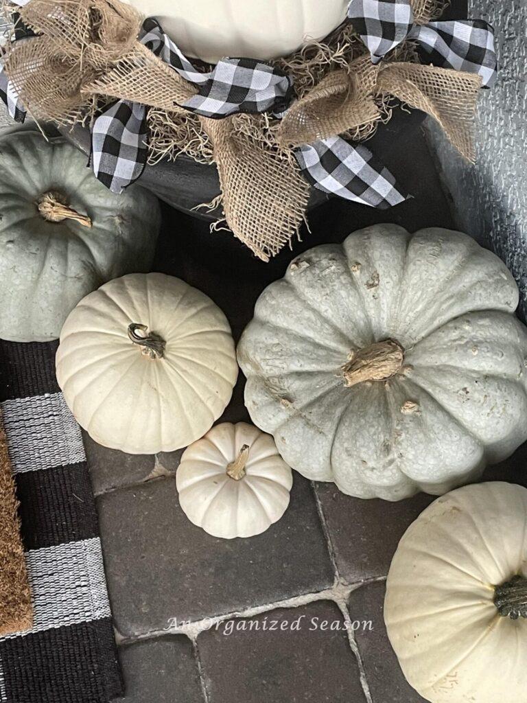 Green and white pumpkins on a brick patio get us in the mood to make a Fall Bucket List.