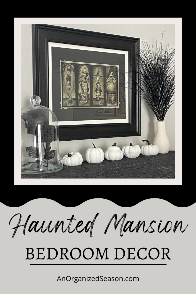 Haunted Mansion artwork hanging in a bedroom.