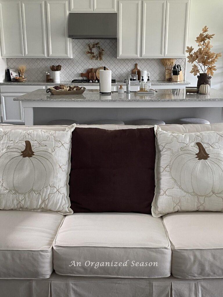 Our #7 Fall decor idea is to add throw pillows with pumpkins on a couch! 