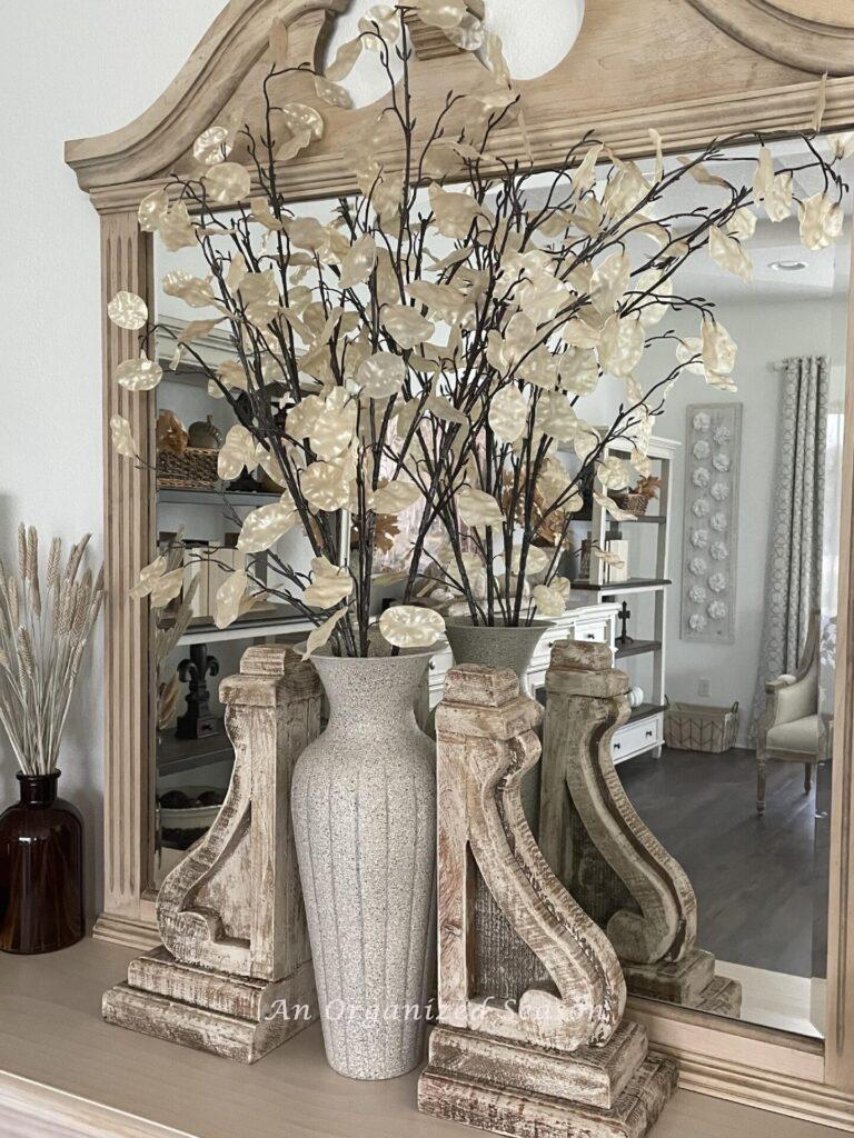 Our #4 Fall decor idea is to add neutral fall stems to a tall vase on a console table. 