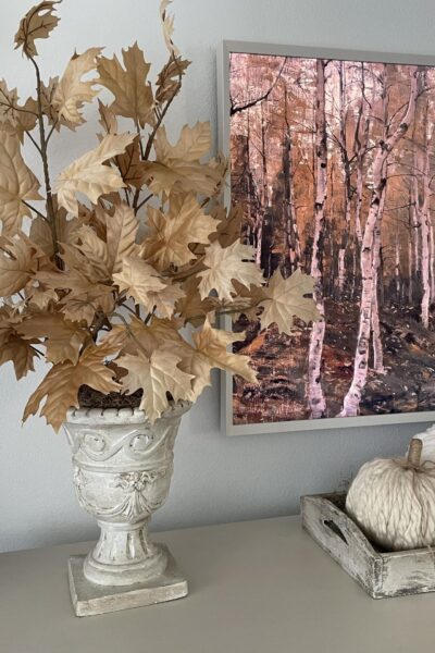 White vase filled with tan leaf stems