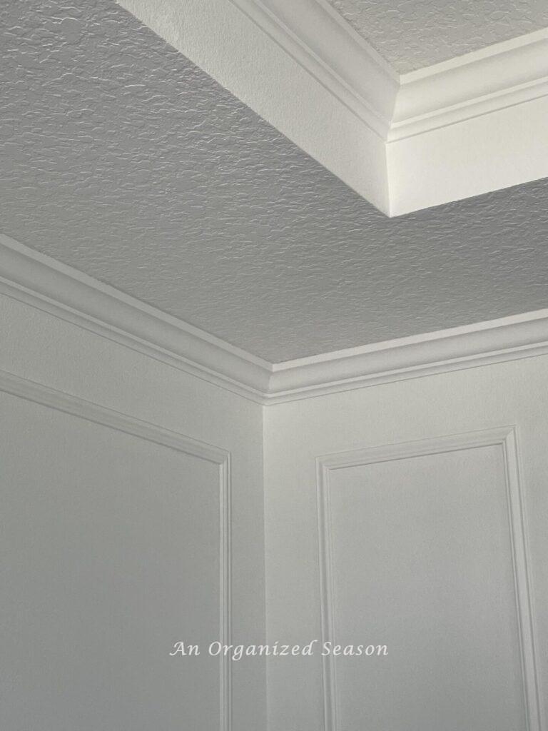 Step three of our dining room makeover was to add crown molding to the ceiling.