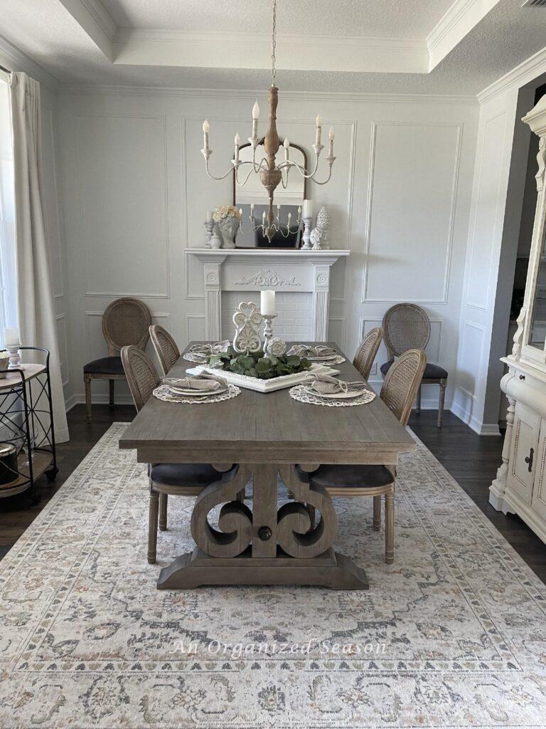 A white formal dining room with a fireplace. 