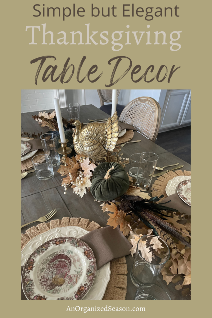 Thanksgiving table with a gold turkey, green velvet pumpkin, two gold candlesticks and organics. 