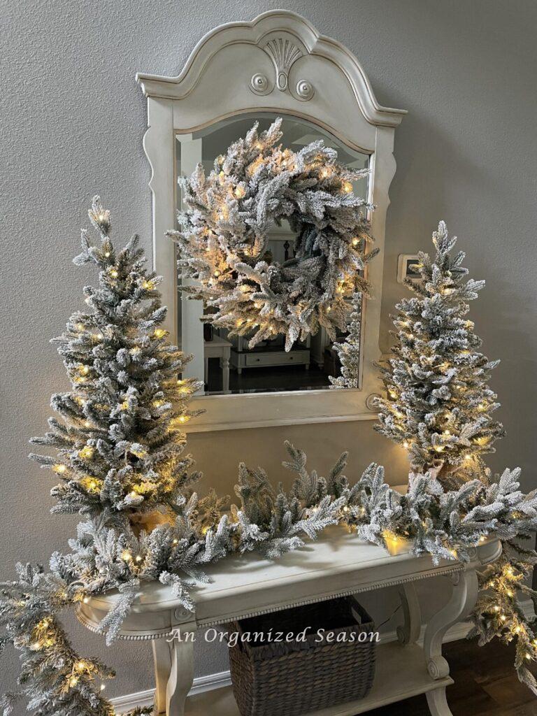 A King of Christmas queen flocked set with warm LED lights displayed in a foyer.