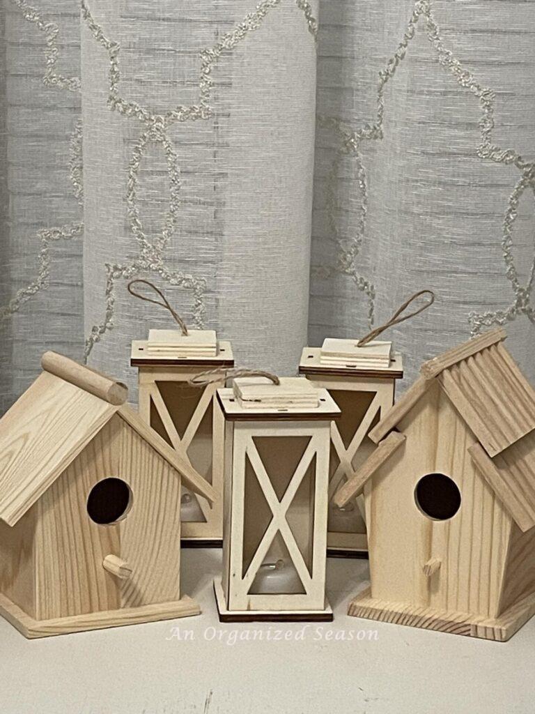 Plain birdhouses and lanterns used to make DIY wood Christmas ornaments.