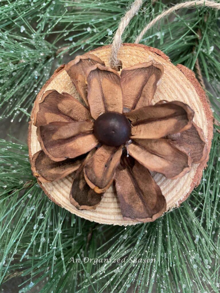Glue a brown wood bead in the center of the pinecone flower ornament.
